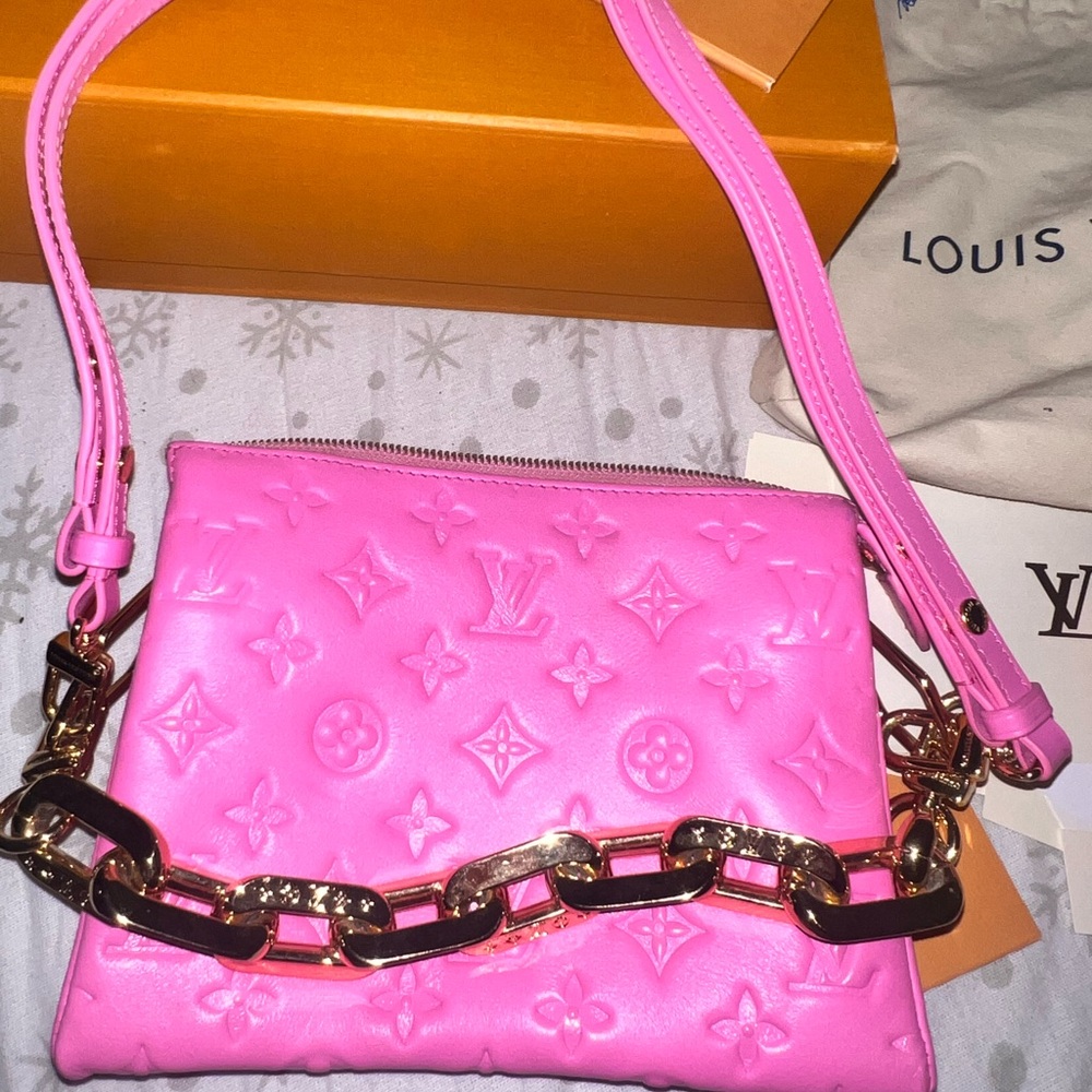 Pink Louis Vuitton bag with gold hardware.